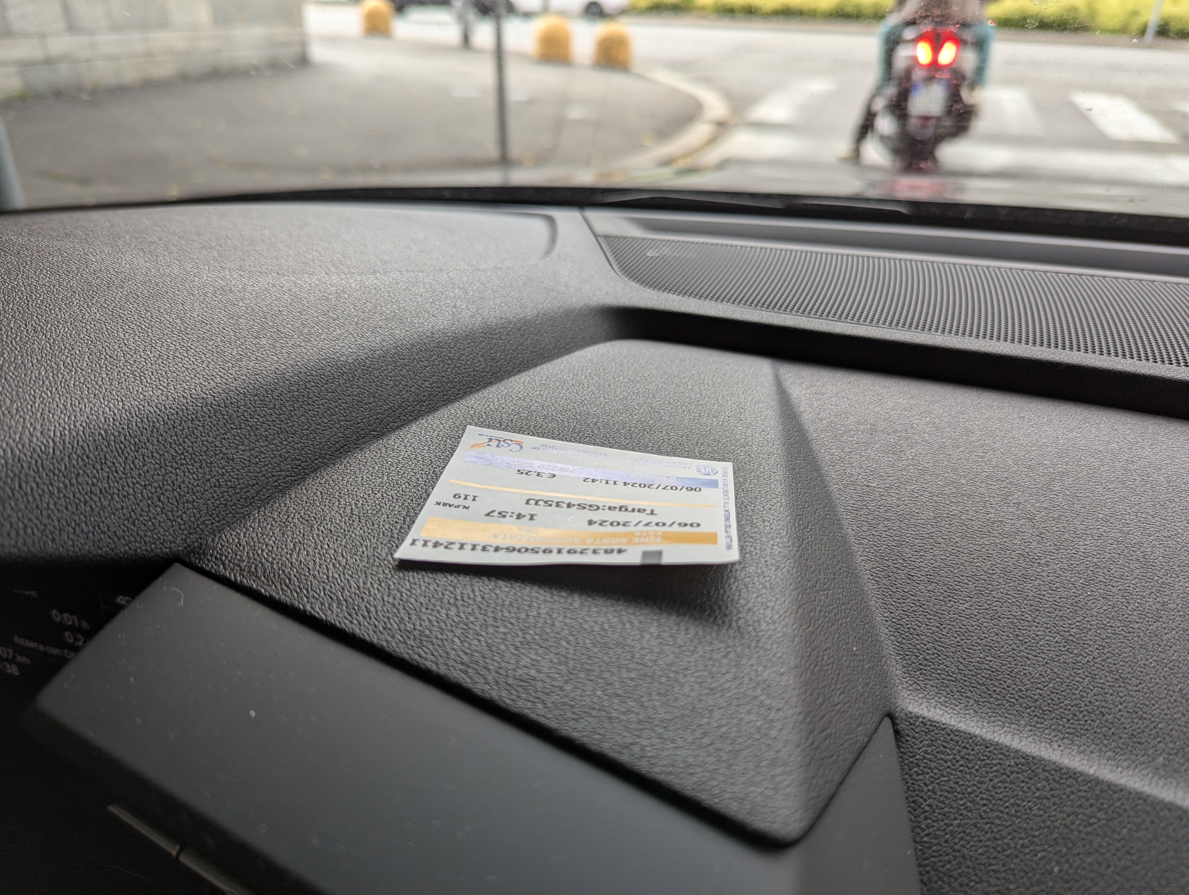 車のダッシュボードの上に置かれたイタリアの駐車券